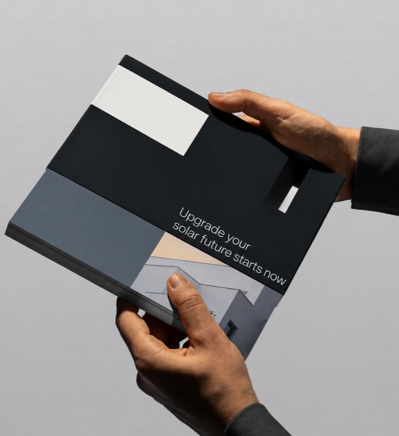 Hands opening the "Upgrade your solar future starts now" brochure